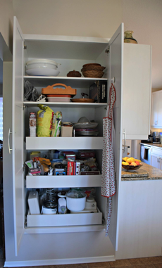 Pantry storage with pull out shelving.