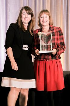 Gail Asper receving the award with a representative from Investors Group, the award sponsor.