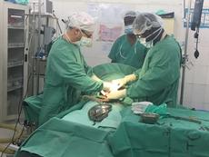 Dr Michael Boroditsky (left) performing sergery