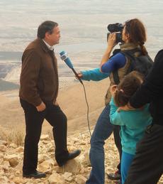 Uzi Dayan being filmed by a German crew on Sarbata with the expanse of the Jordan valley in background
