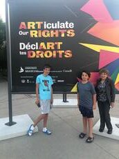 R to L: Tova Vickar with her grandson's Vaughn and Mason at the ARTiculate Our Rights Exhibit
