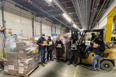 Share the Magic’s Christine Melnick (3rd from left) with employees of The North West Company at its Winnipeg warehouse with thousands of books packaged for the trip to northern communities. Almost 9,000 books will be distributed free to children and families in four Indigenous communities that don’t have easy access to books