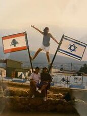 Fern in Israel standing between two flags