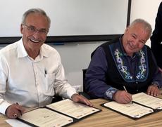 Larry Vickar of the Vickar Automotive Group (left) and David Chartrand, President of the Manitoba Métis Federation, sign an agreement on May 2 in Beersheba, Israel, to establish a parntership for research, education, and cultural exchange between the Manitoba Métis Federation and Ben-Gurion University located in Be'er Sheba. The Vickar Automotive Group is contributing funds toward the partnership.